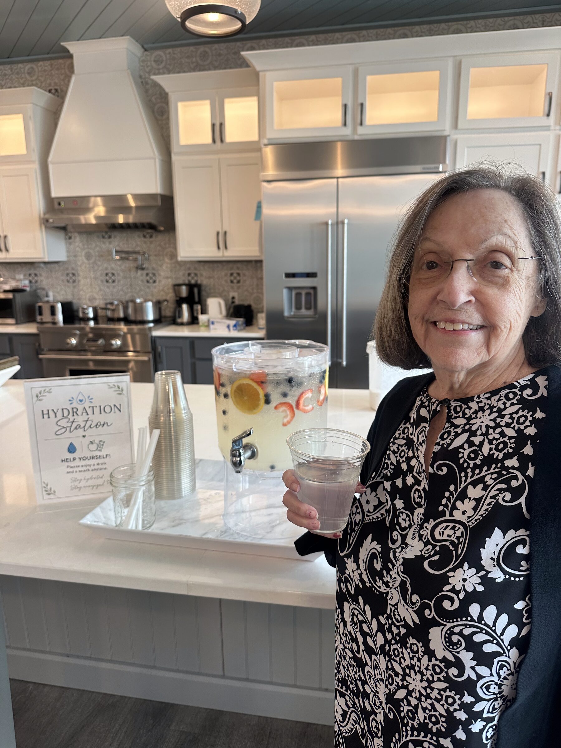 A resident in the neighborhood common space at Remember Me Senior Care